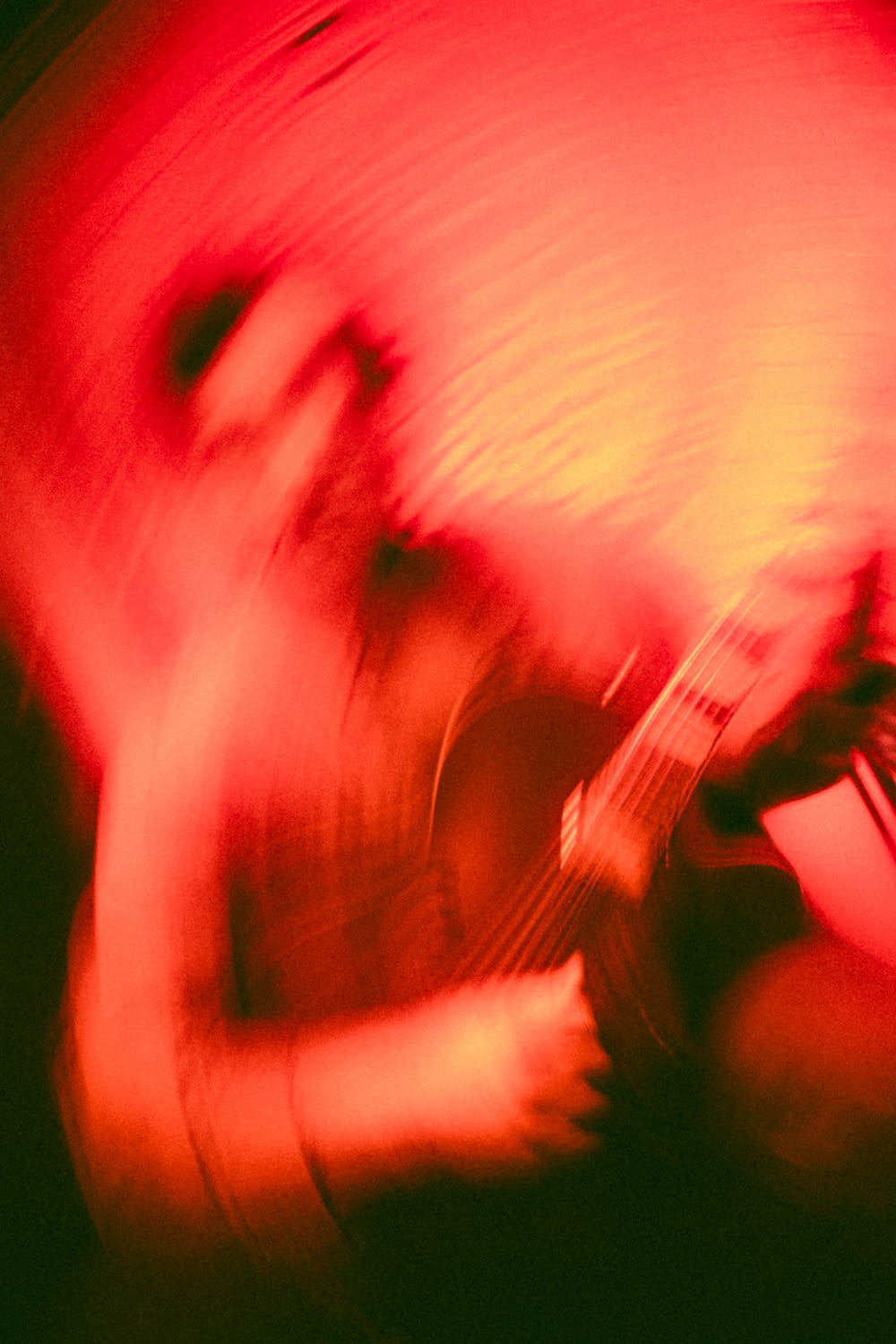 a blurry photo of a person playing a guitar