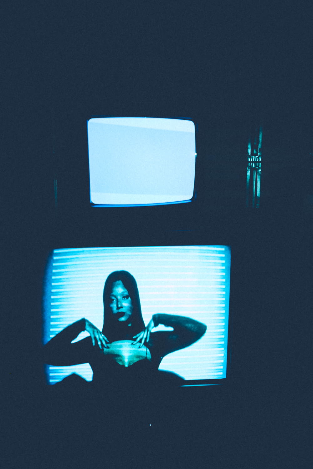 a woman is sitting in front of a television