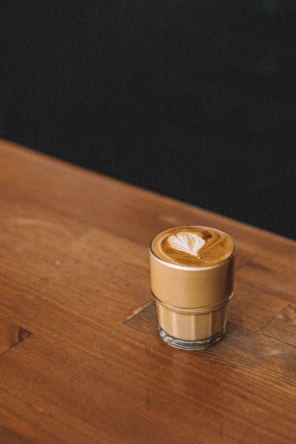 a cappuccino sitting on a wooden table
