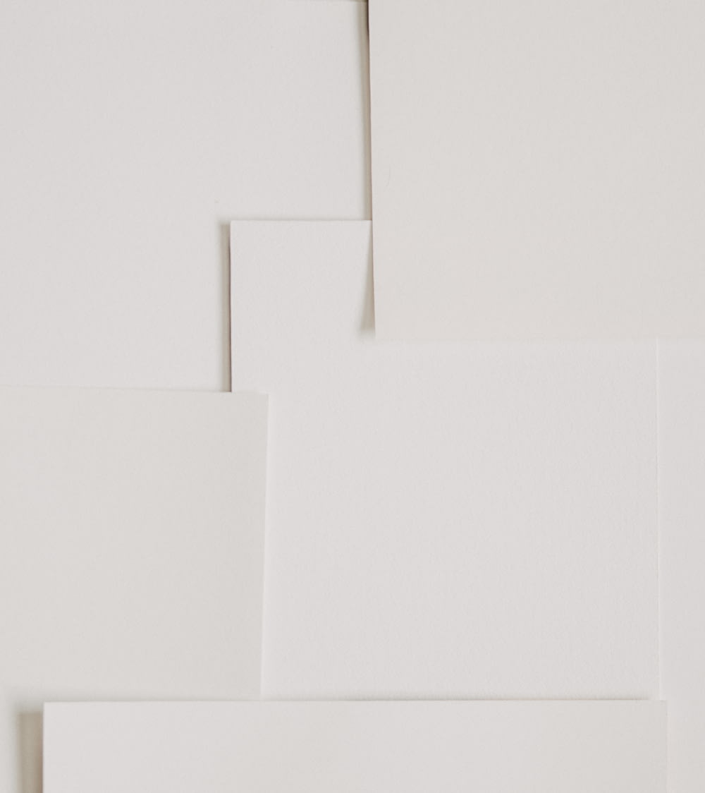 a white wall with several pieces of paper on top of it