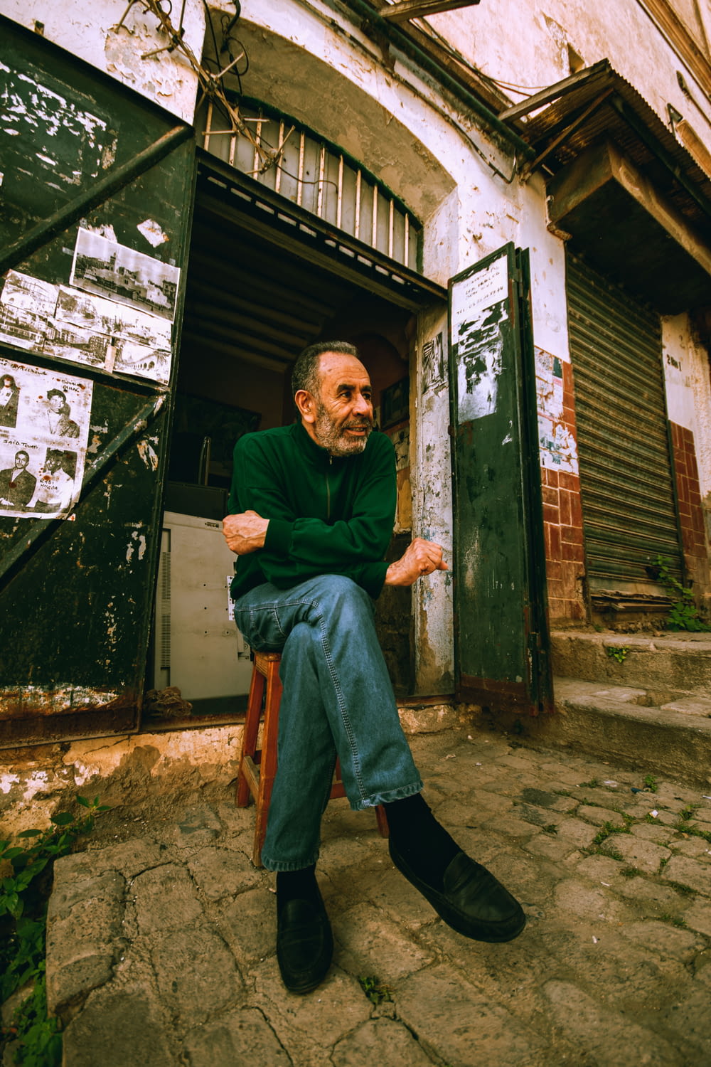 a man sitting on a chair in front of a building