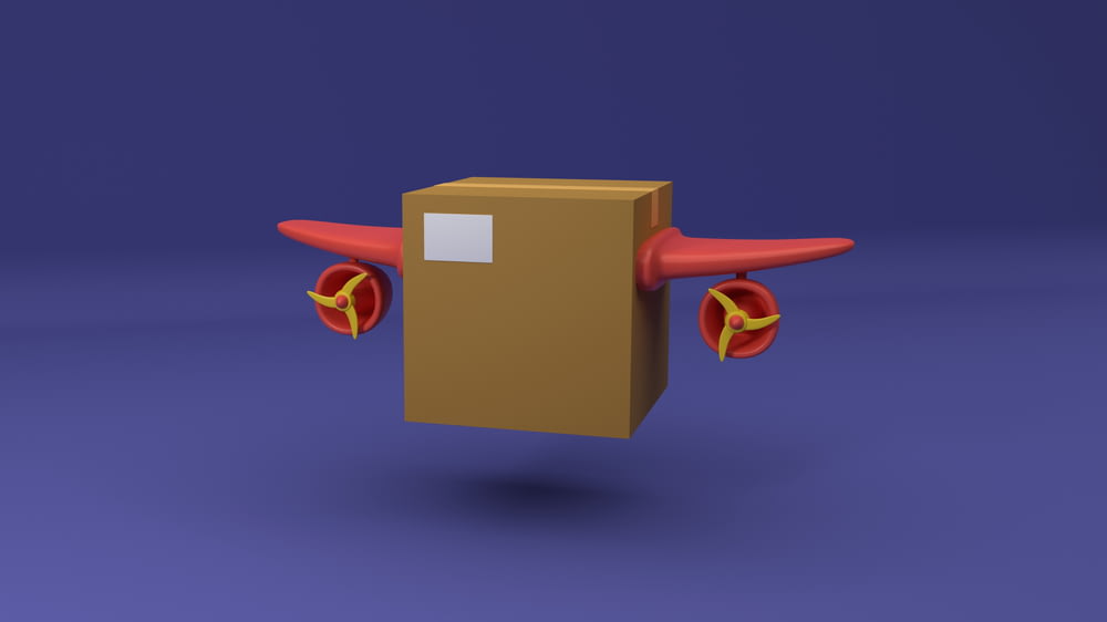 une boîte en carton avec une hélice rouge dessus