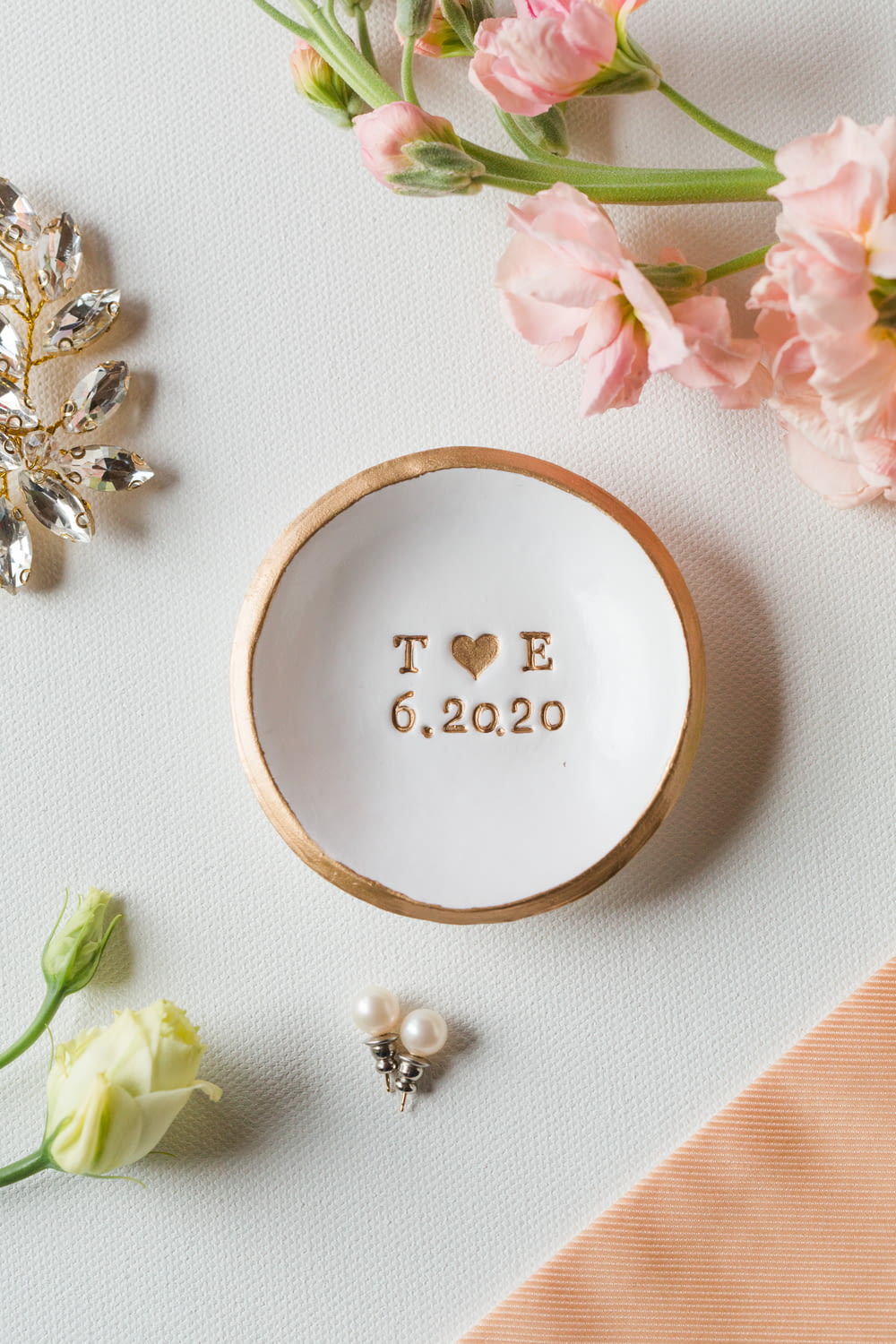 a white bowl with the word toe on it next to flowers