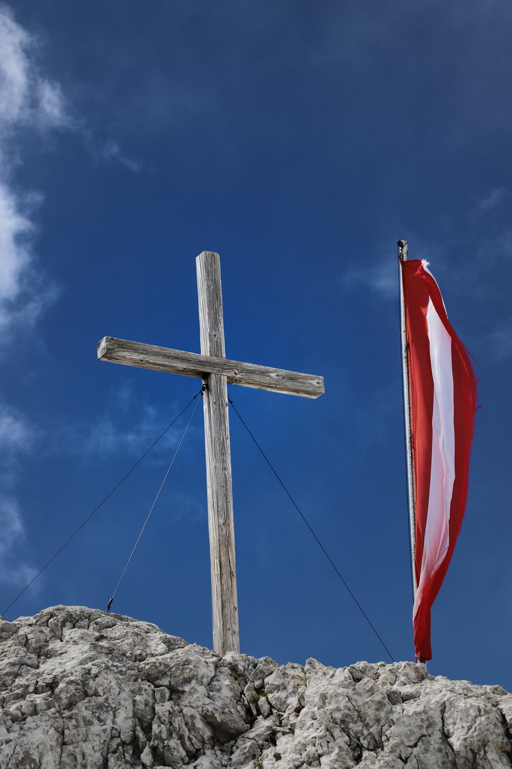 a cross and a flag on top of a hill