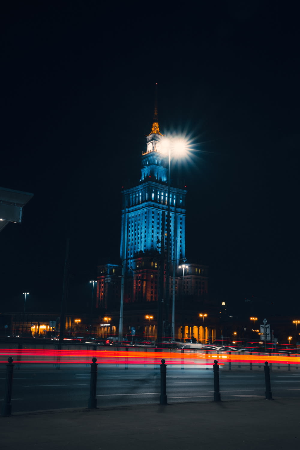 a tall building with a clock tower lit up at night