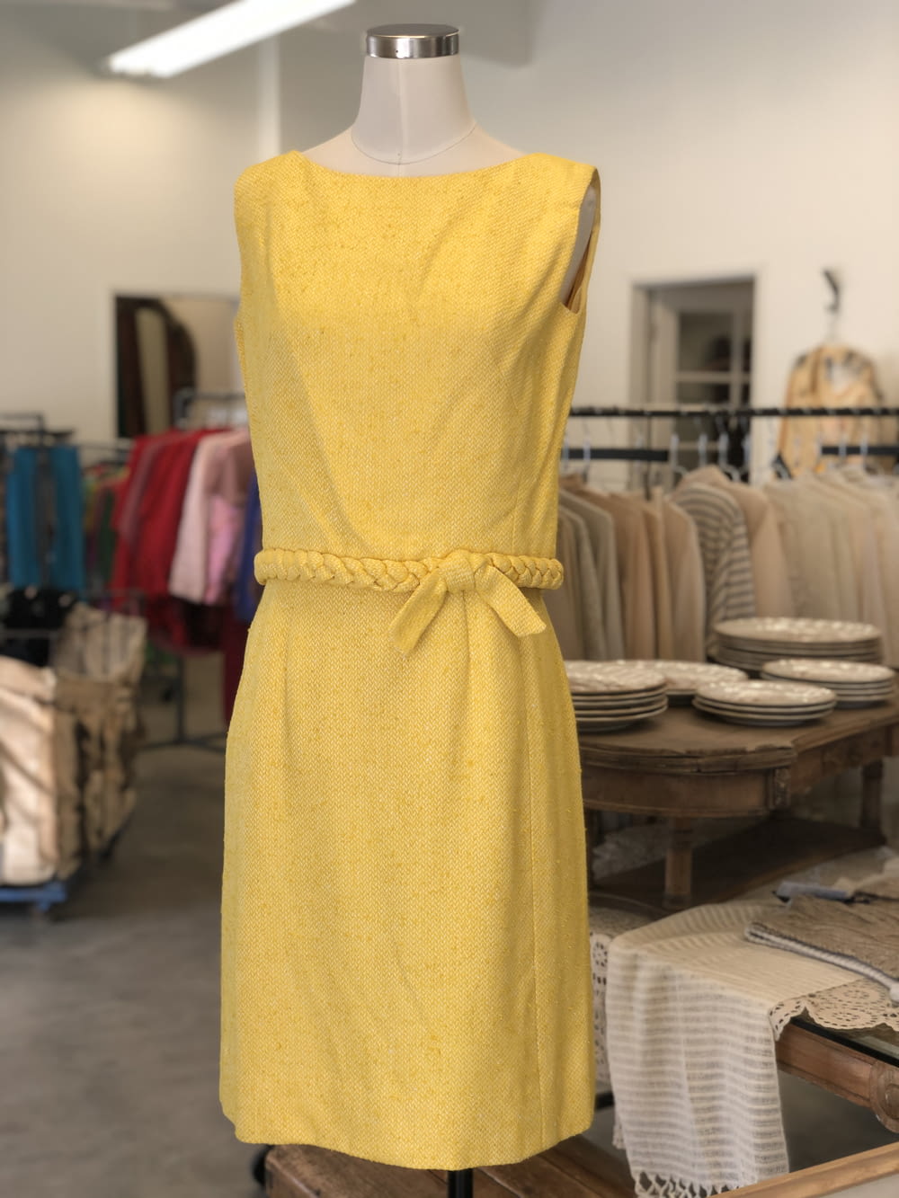 a yellow dress on a mannequin in a store