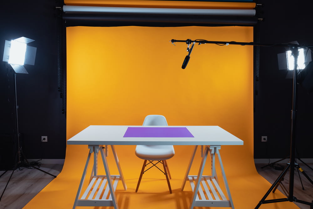 a photo studio with a table and chairs