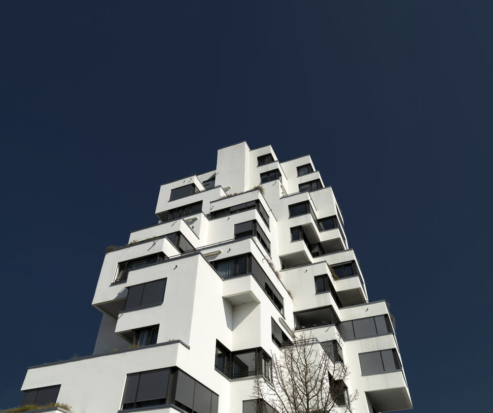 a tall white building with balconies and balconies