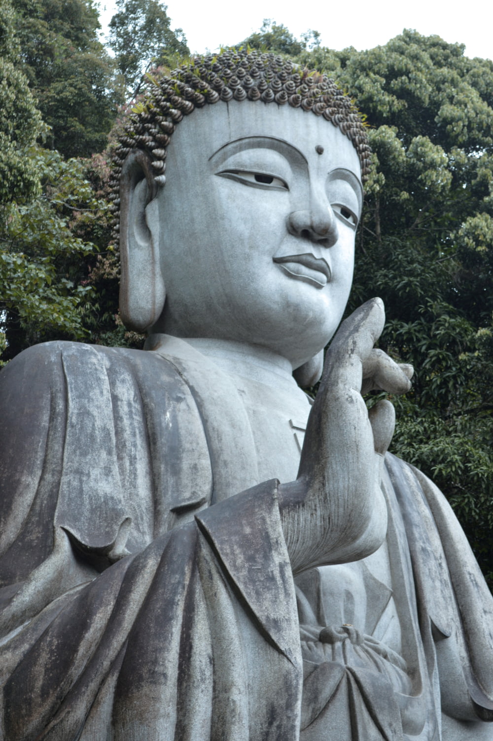 a statue of a buddha holding a bird