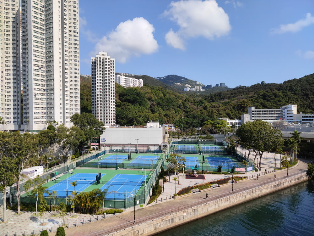 an aerial view of a tennis court surrounded by tall buildings
