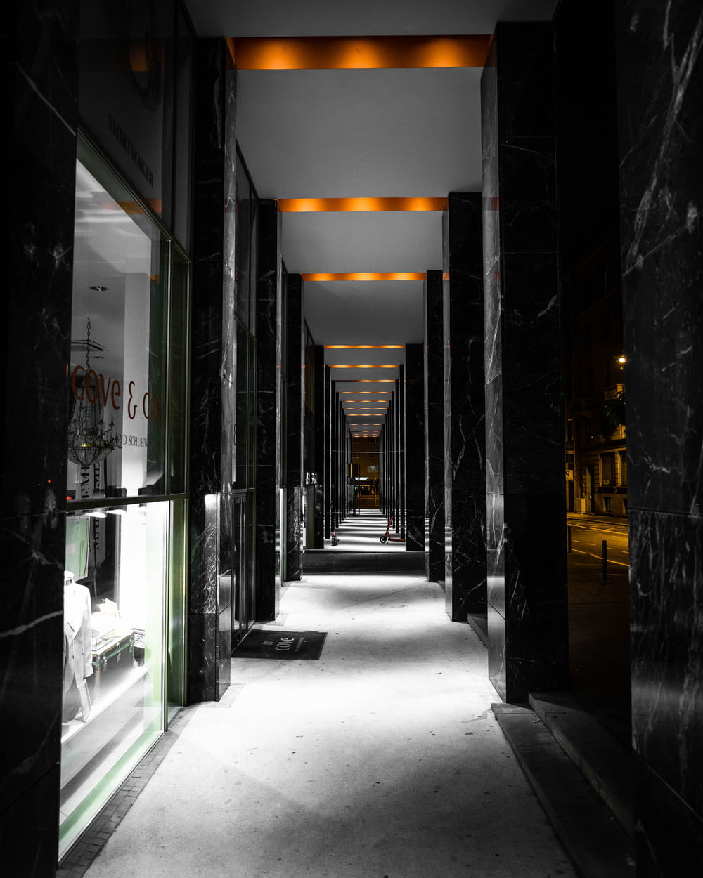 a long hallway with black and white marble walls