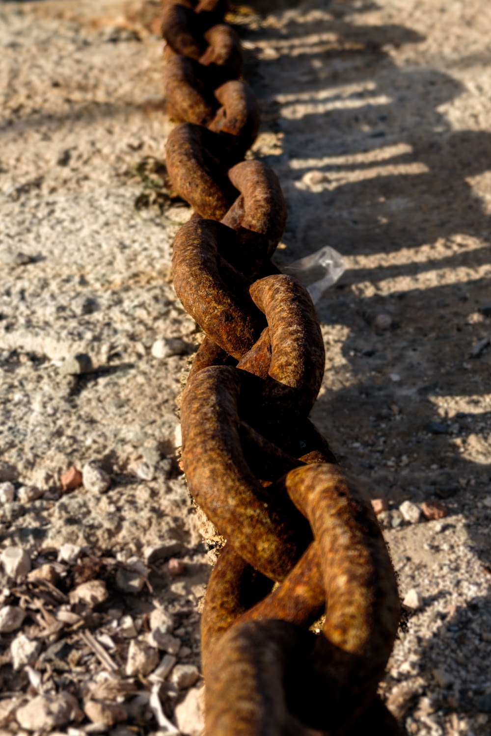 a rusty chain on the side of a road