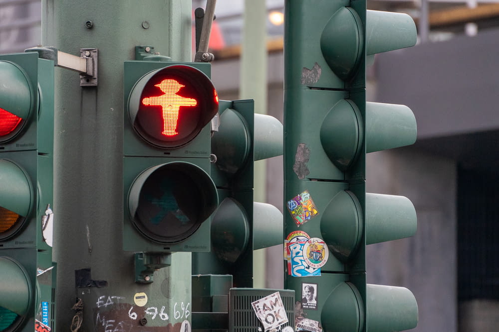 a traffic light with a sticker on it