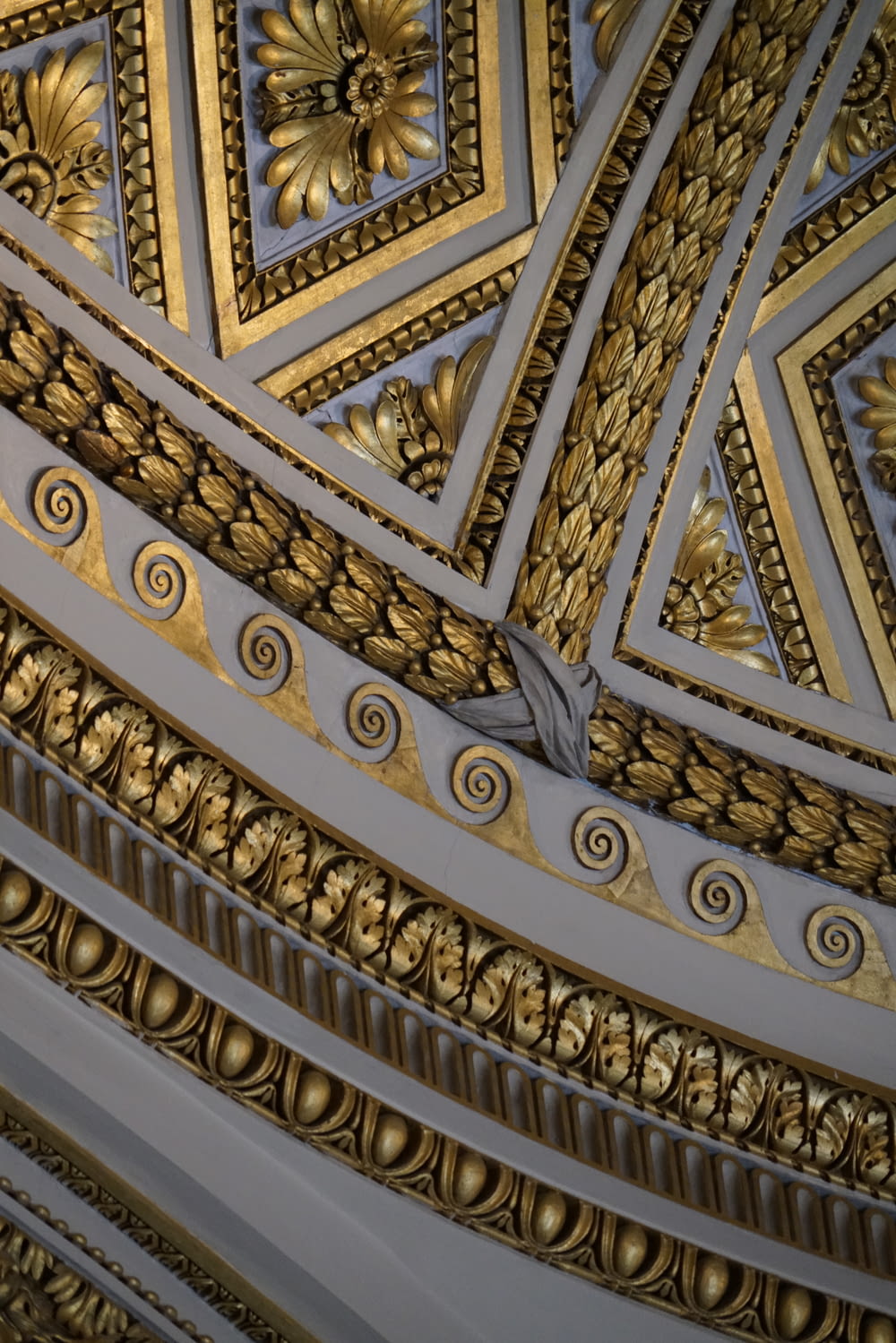 a close up view of a ceiling with gold decorations