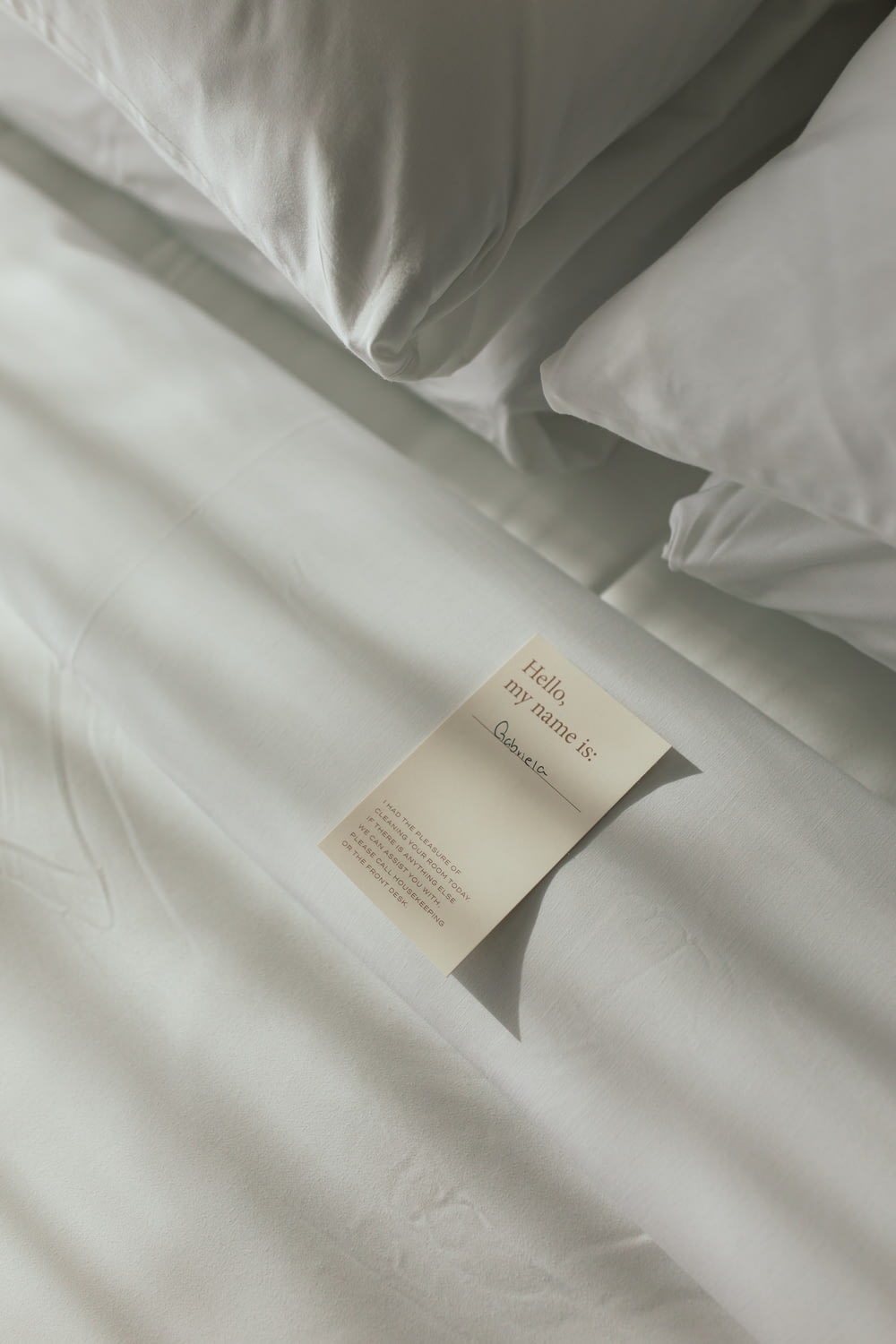 a sheet of paper on a bed with white sheets