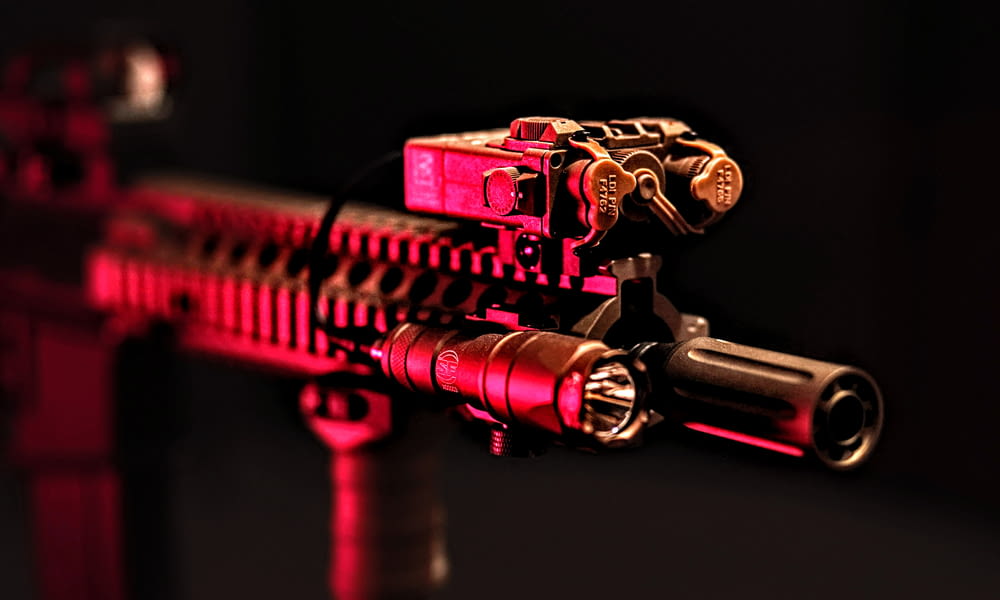 a close up of a red and black machine gun