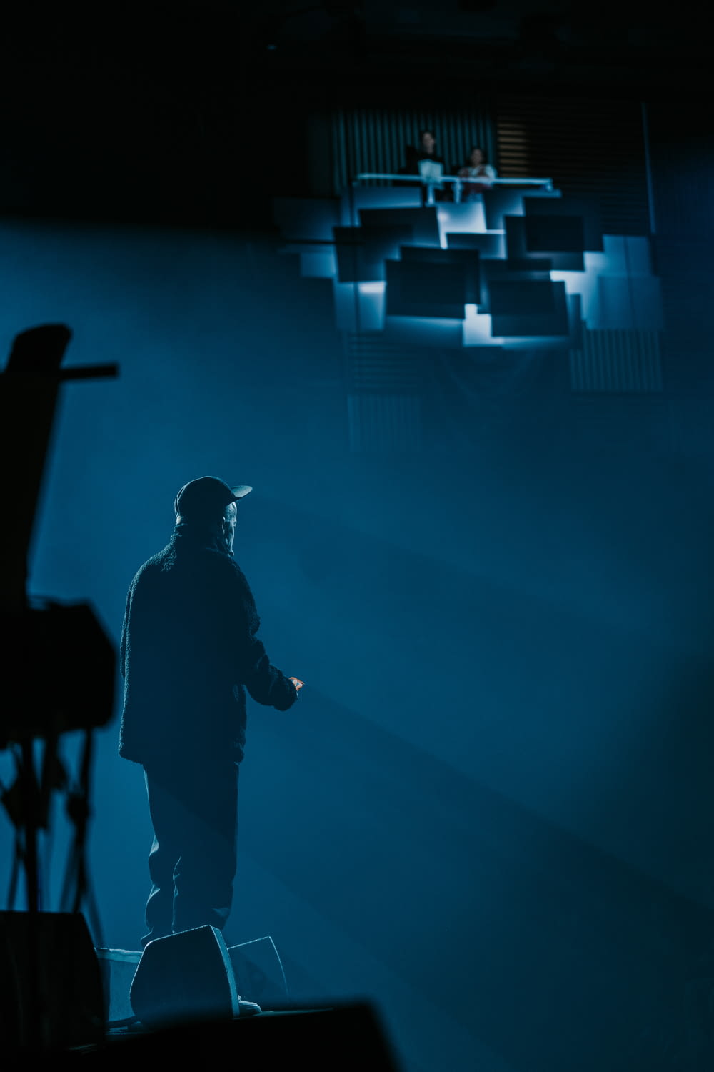 a man standing on a stage in the dark