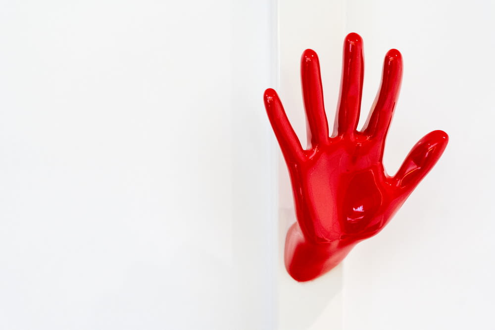 a red hand on a white wall
