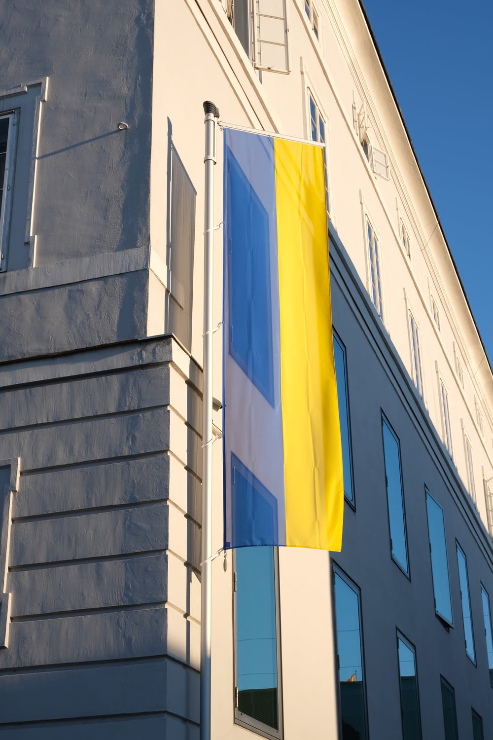 a building with a yellow and blue flag on the side
