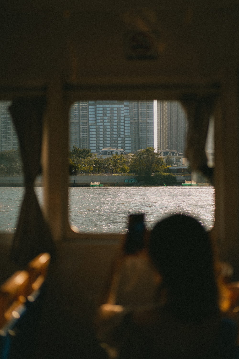 a group of people looking out a window at a body of water