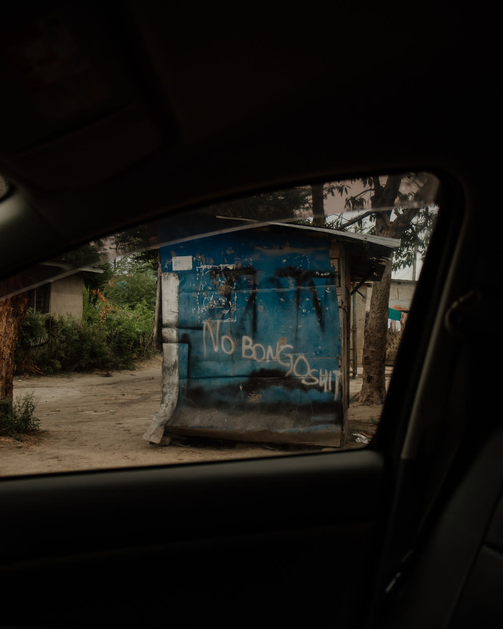 a blue box sitting on the side of a road