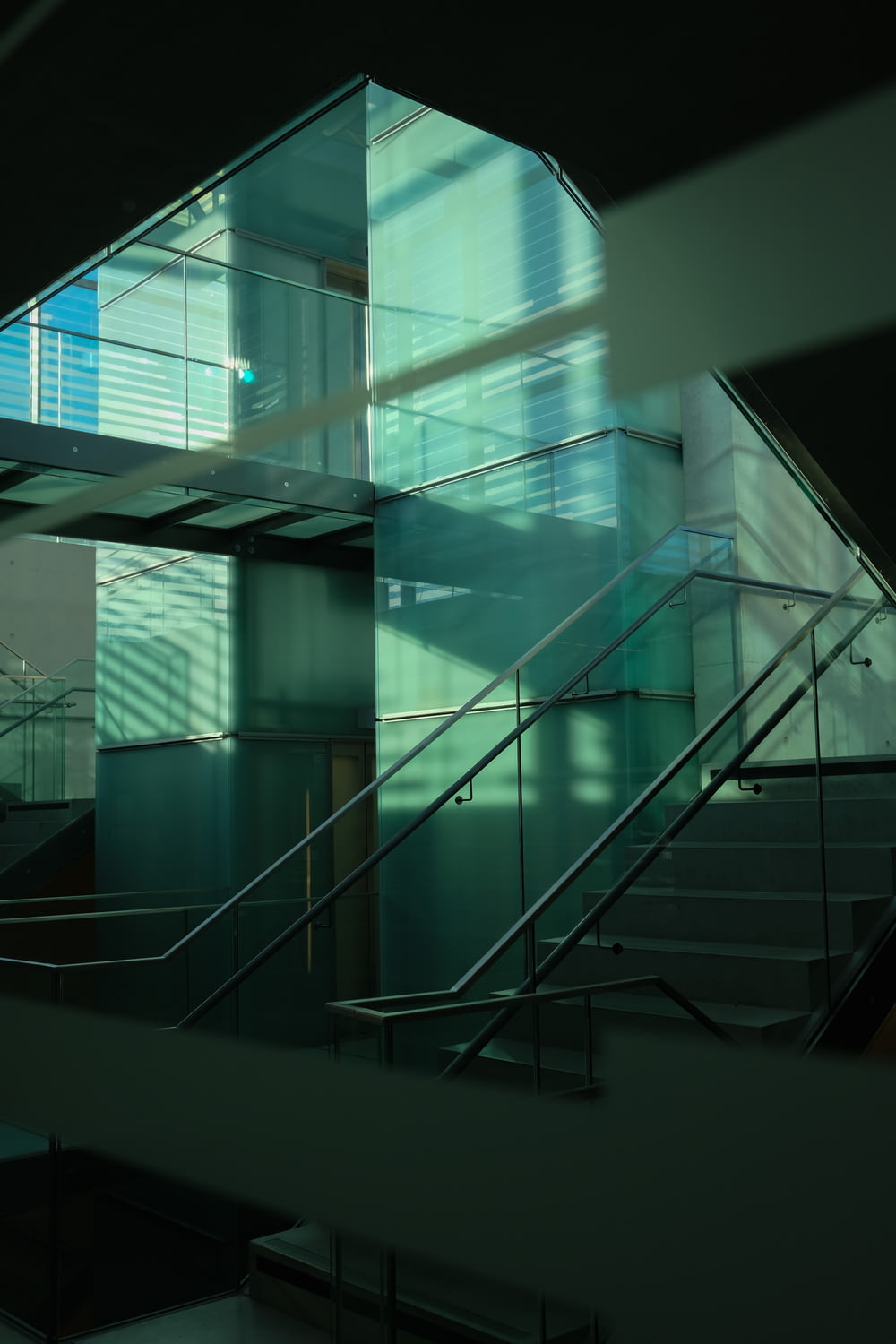 a glass building with a stair case in front of it