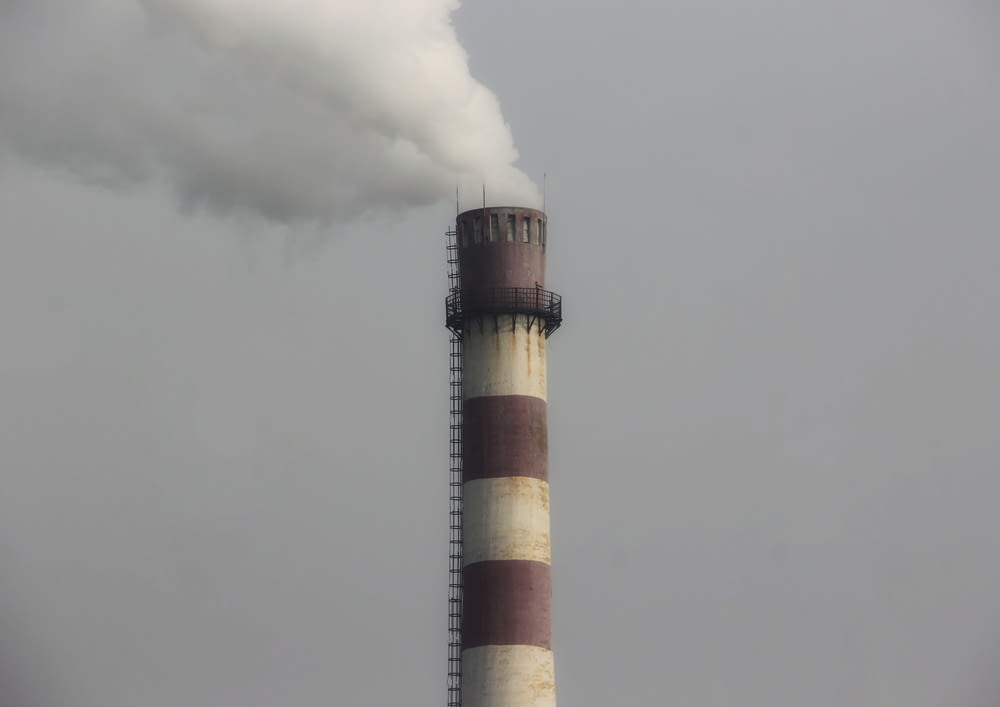 a smokestack emits from the top of a building