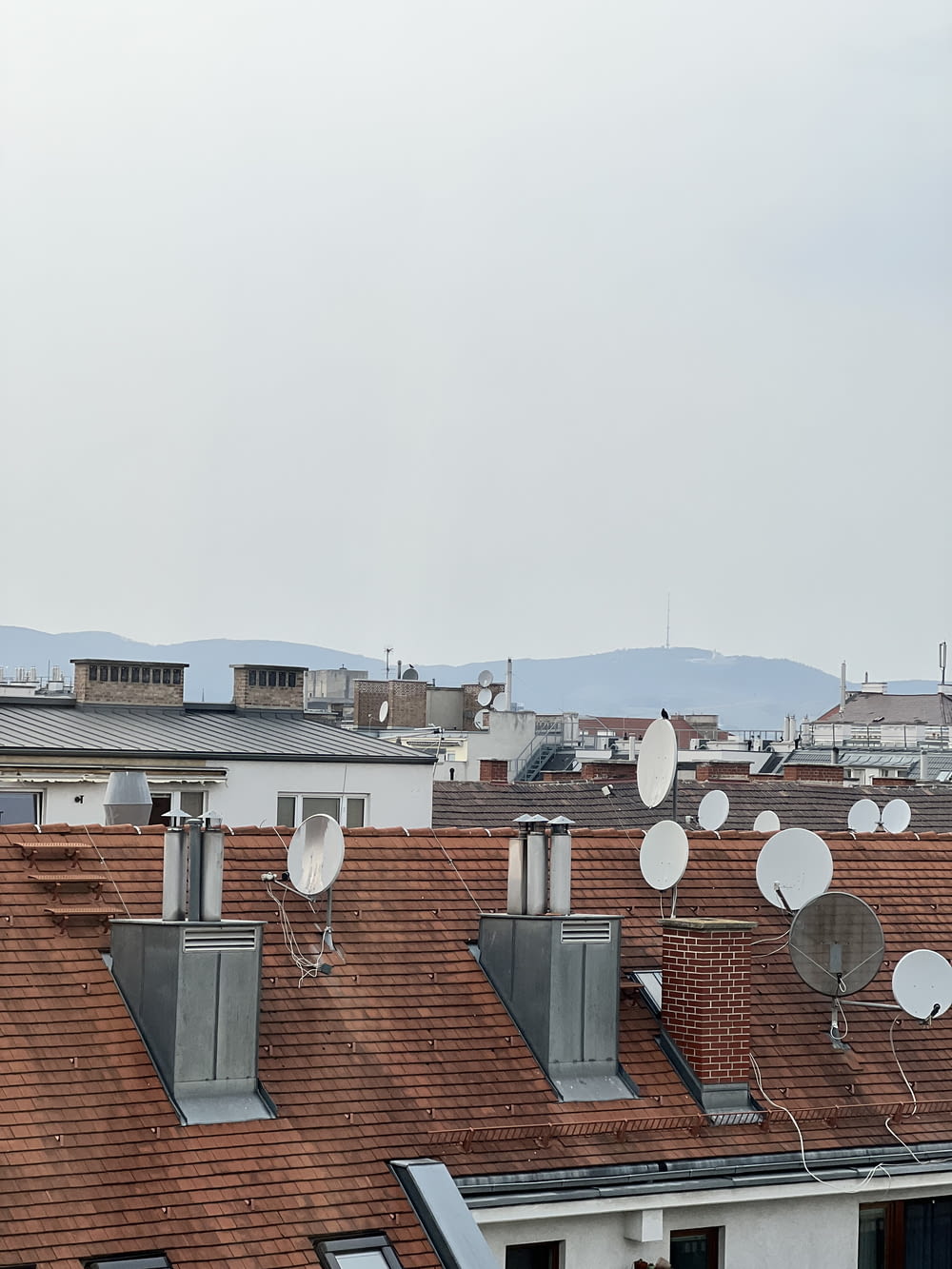 a group of satellite dishes are on the roof of a building