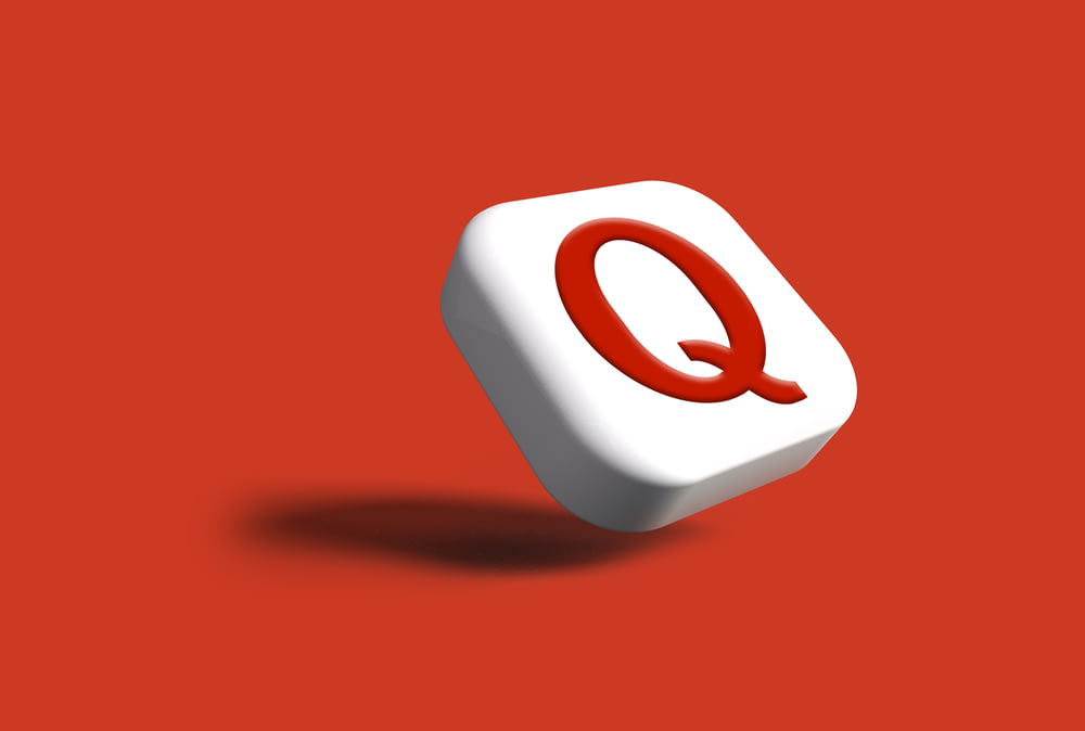a white object with a red q on it