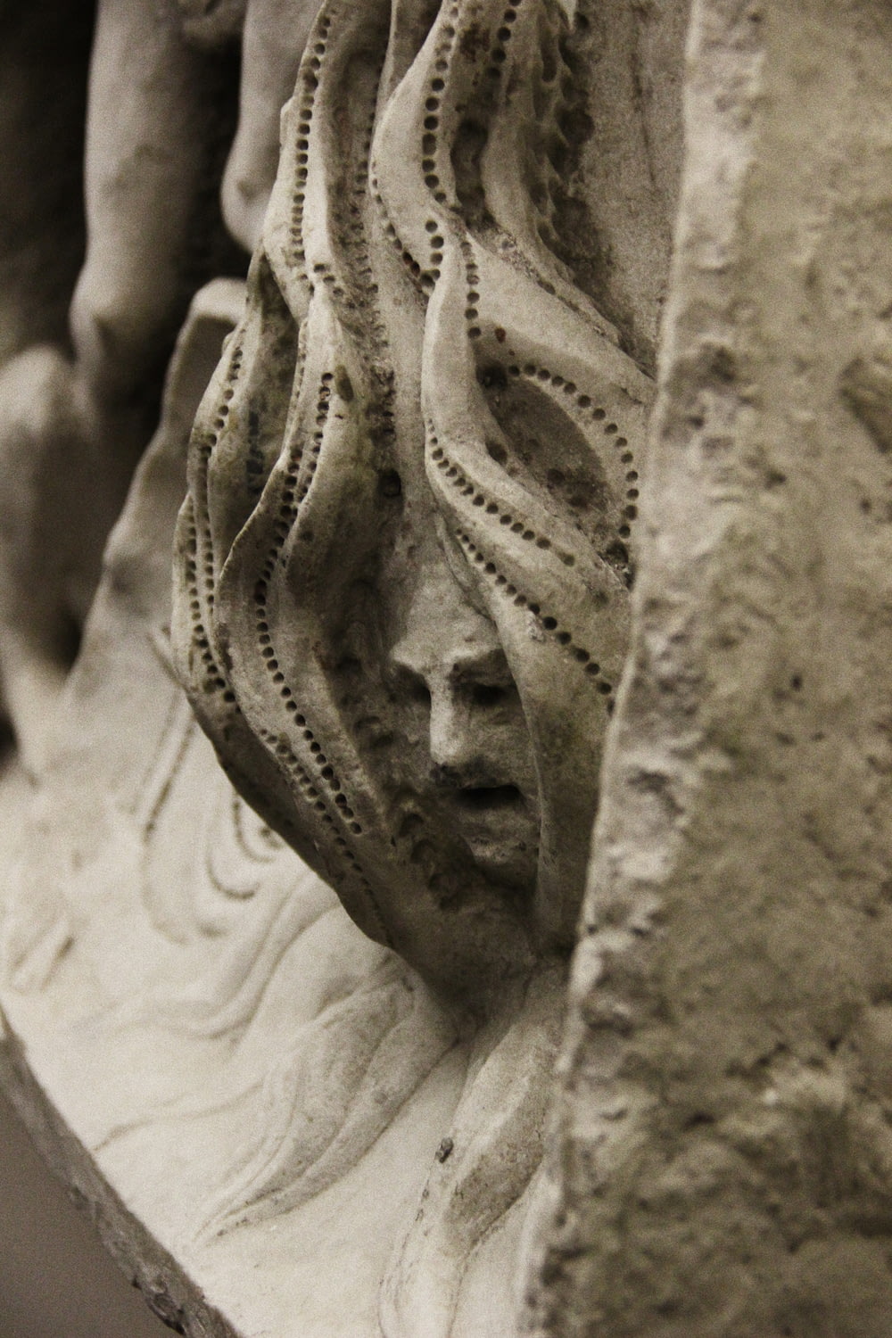 a close up of a statue of a woman's face