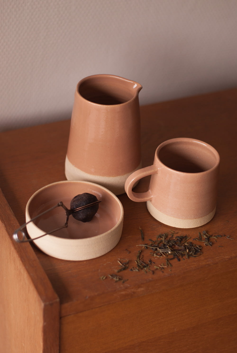 a couple of cups sitting on top of a wooden table