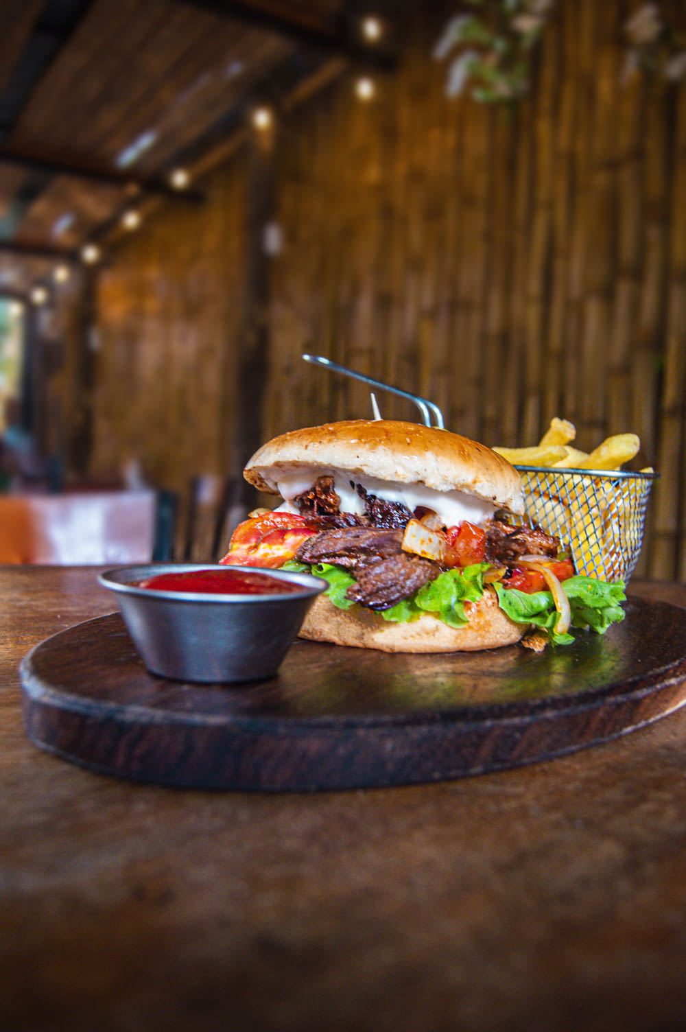 a steak sandwich with fries and ketchup on a plate