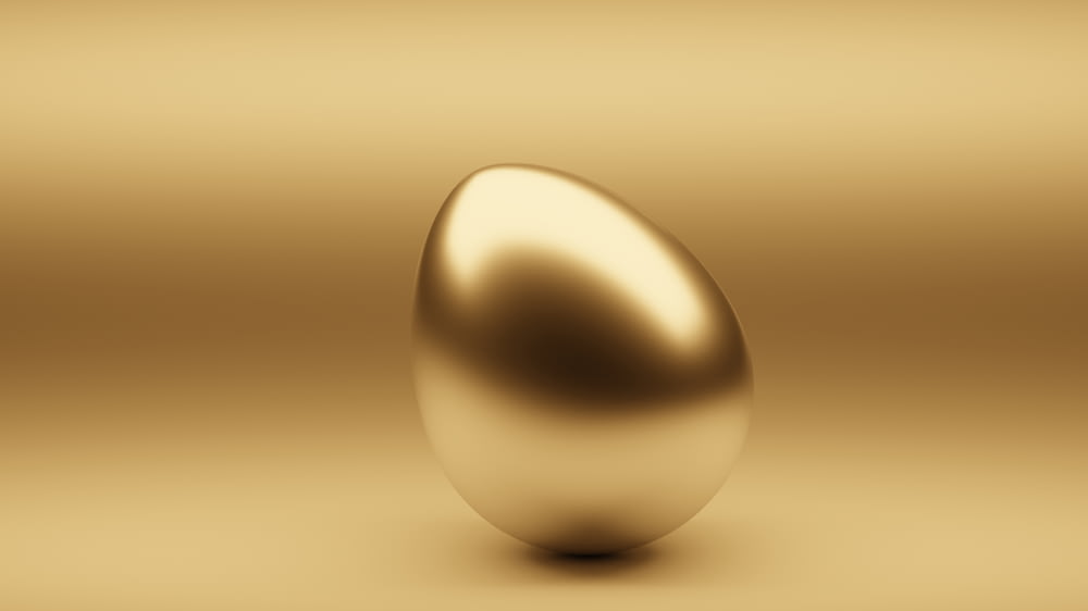 a shiny golden egg on a gold background