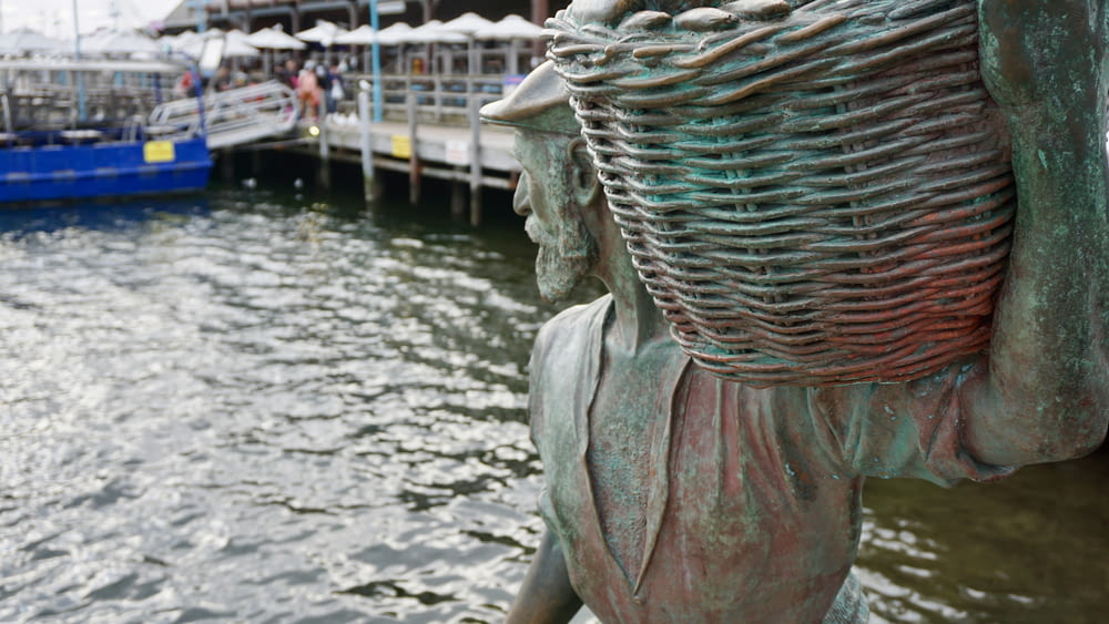 a statue of a woman looking out over a body of water