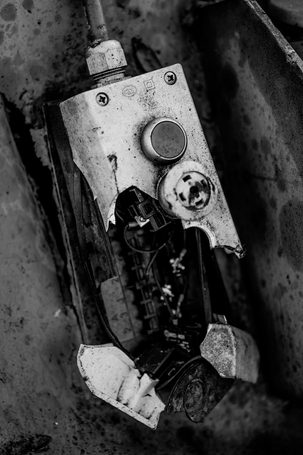 a black and white photo of a broken cell phone