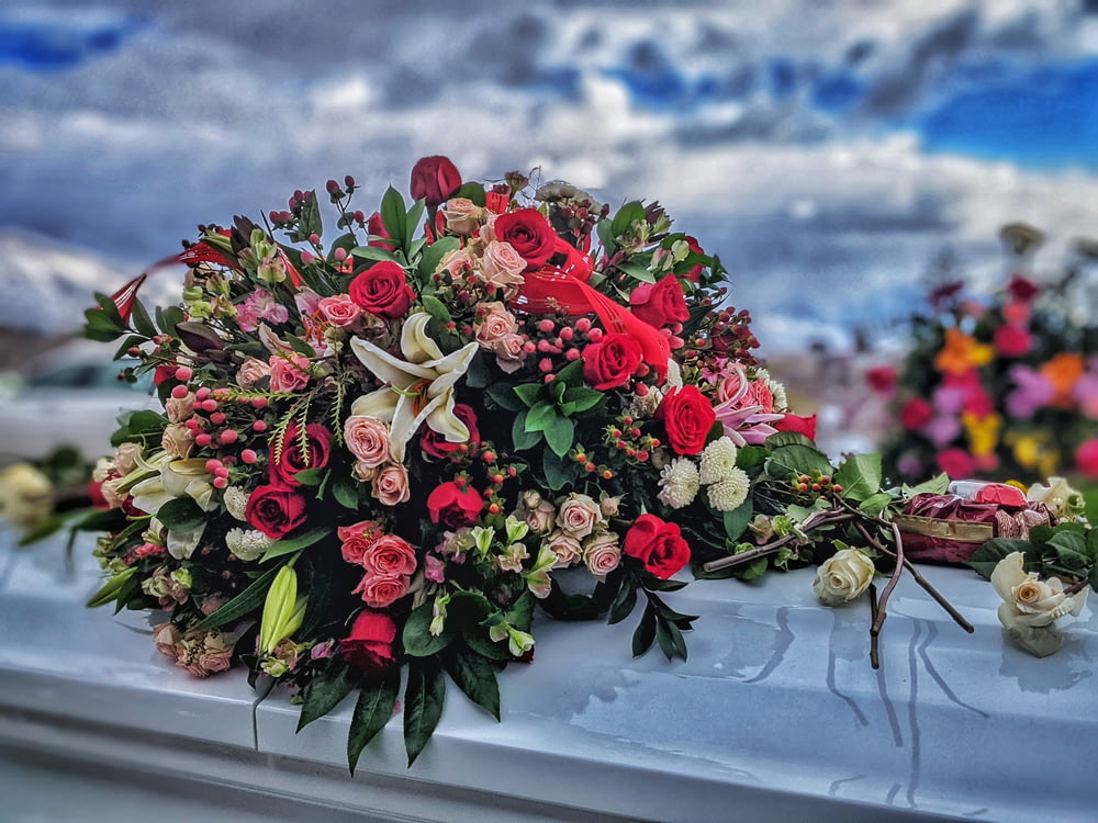 a bunch of flowers sitting on top of a car
