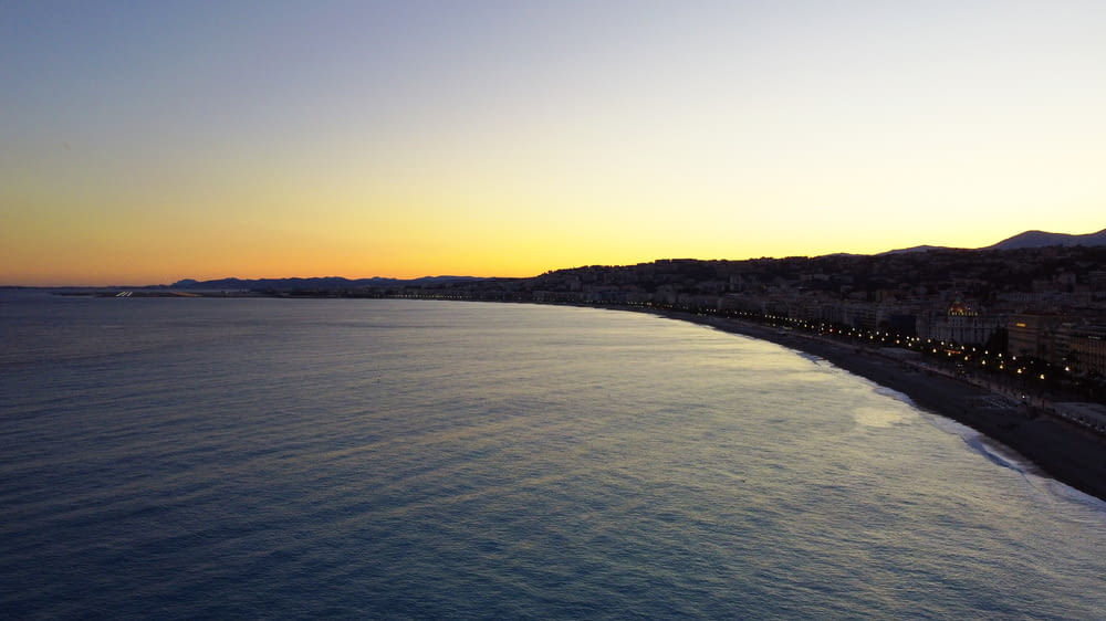 a view of a beach at sunset from a high point of view