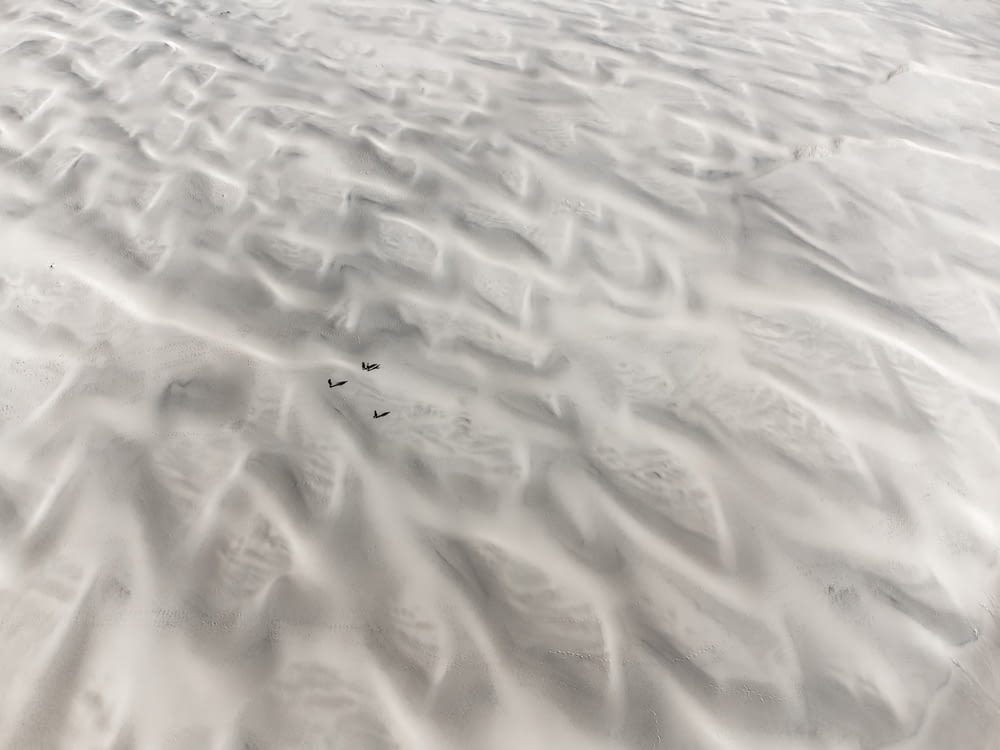 a view of a sandy beach with footprints in the sand