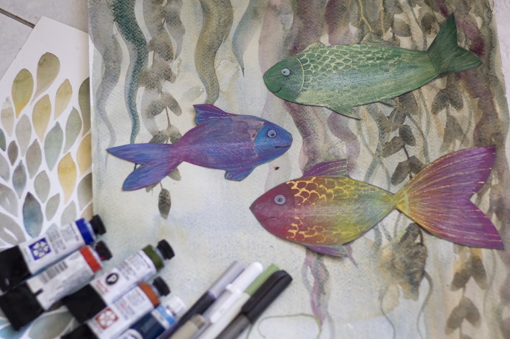 a painting of two fish and some watercolors