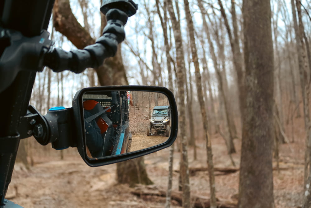 a truck is seen in the rear view mirror of a vehicle