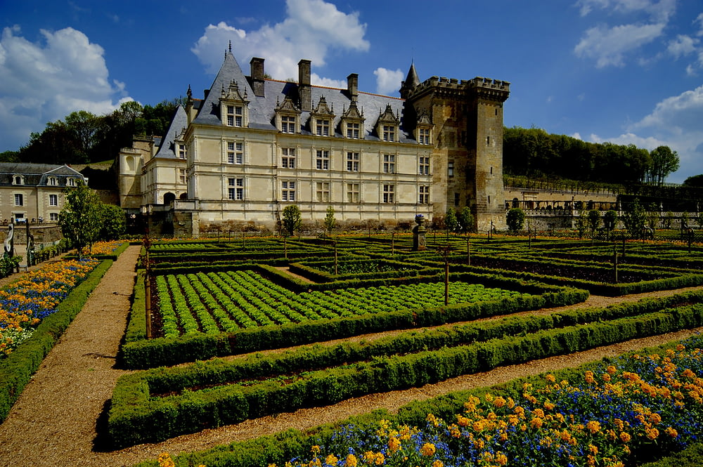a large building with a garden in front of it