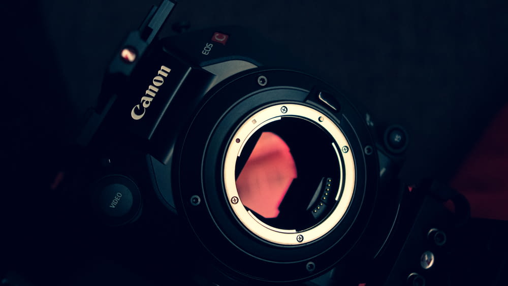 a close up of a camera with a red lens