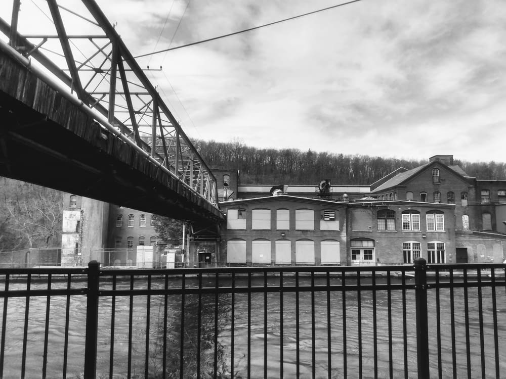 a black and white photo of a building and a bridge