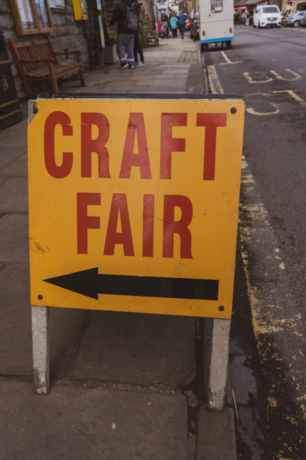 a yellow sign that says craft fair on it