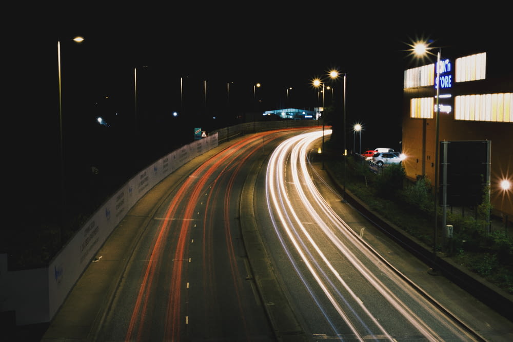 a night time picture of a highway with cars on it