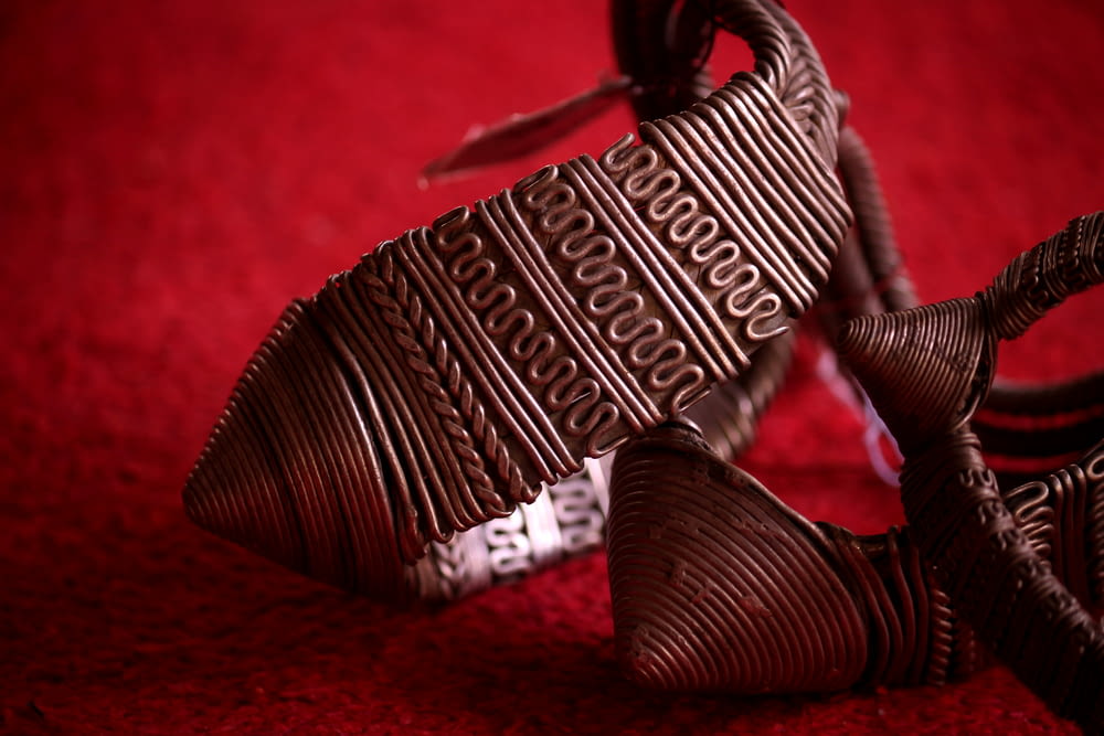 a close up of a chocolate bracelet on a red surface
