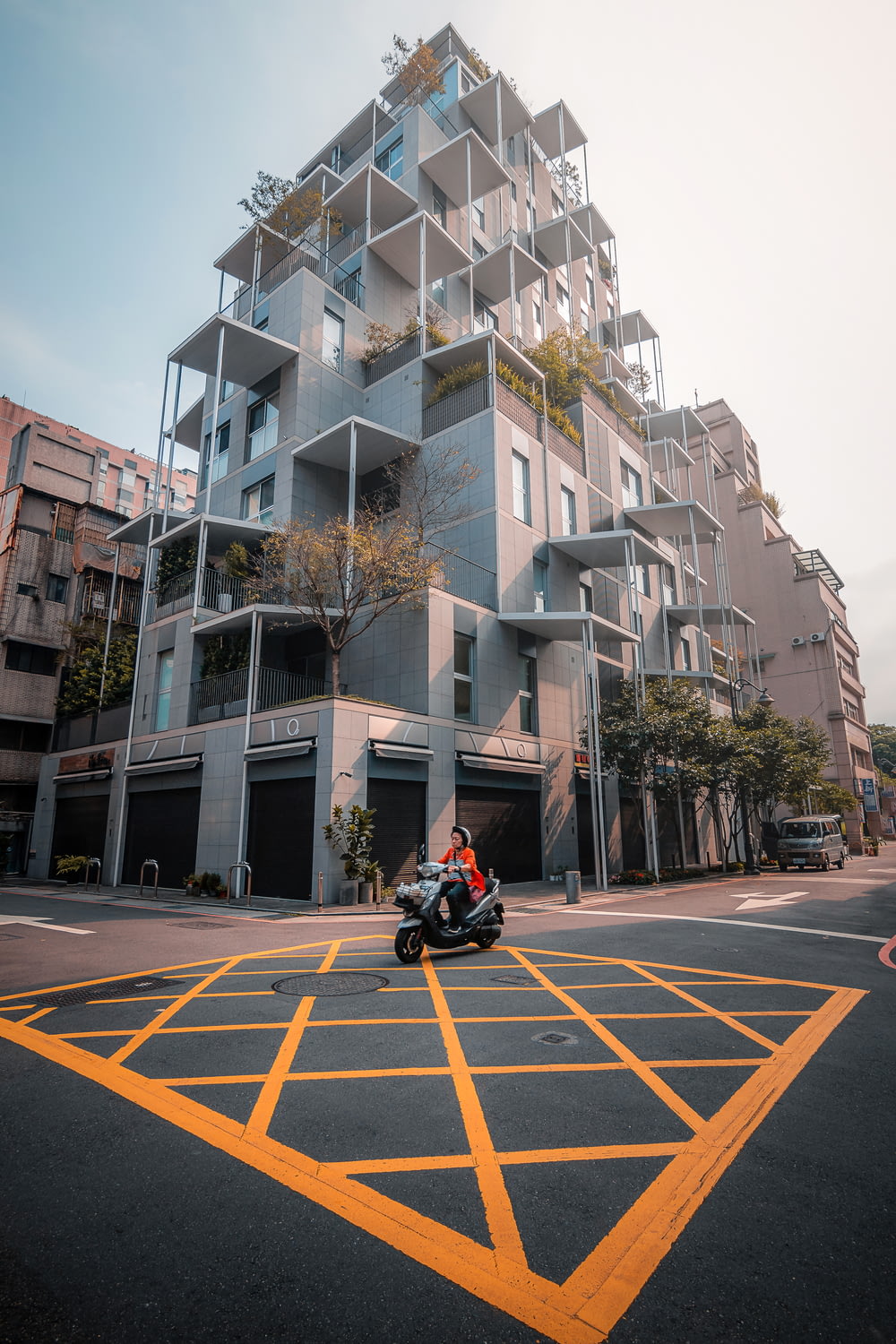 a motorcycle parked in front of a tall building