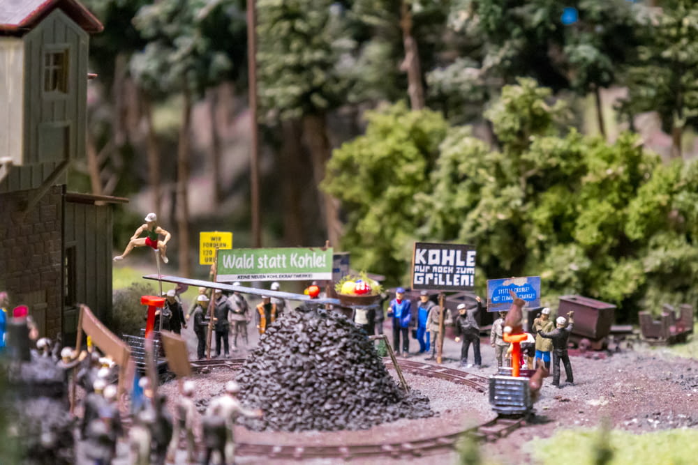 a group of toy figurines on display in a park