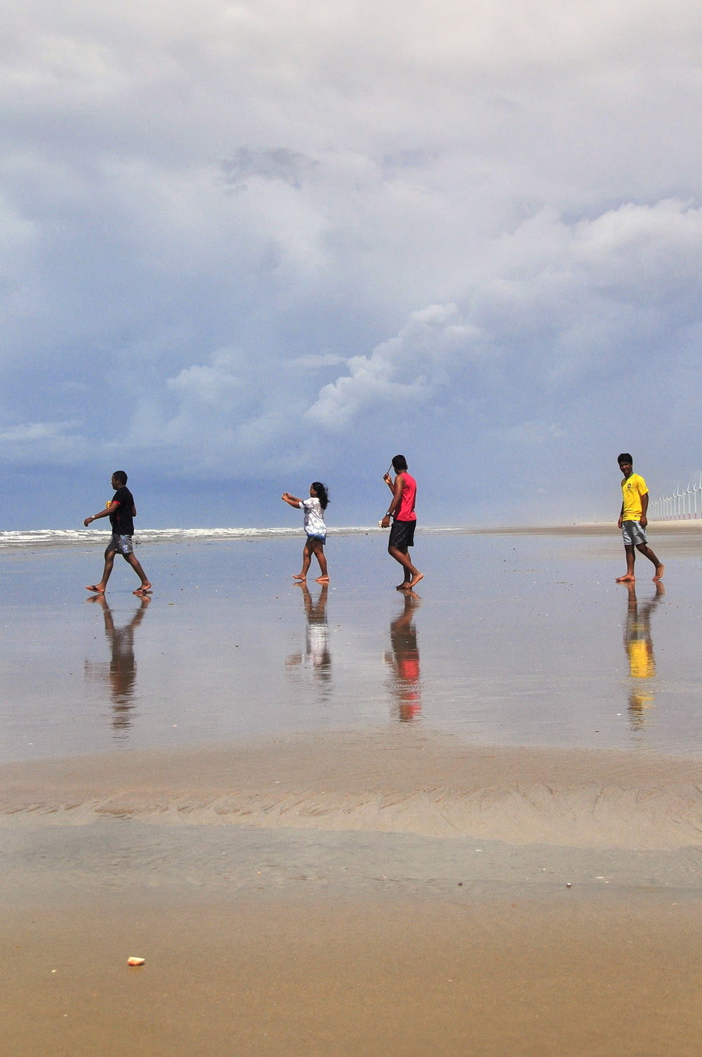 a group of people playing on the beach