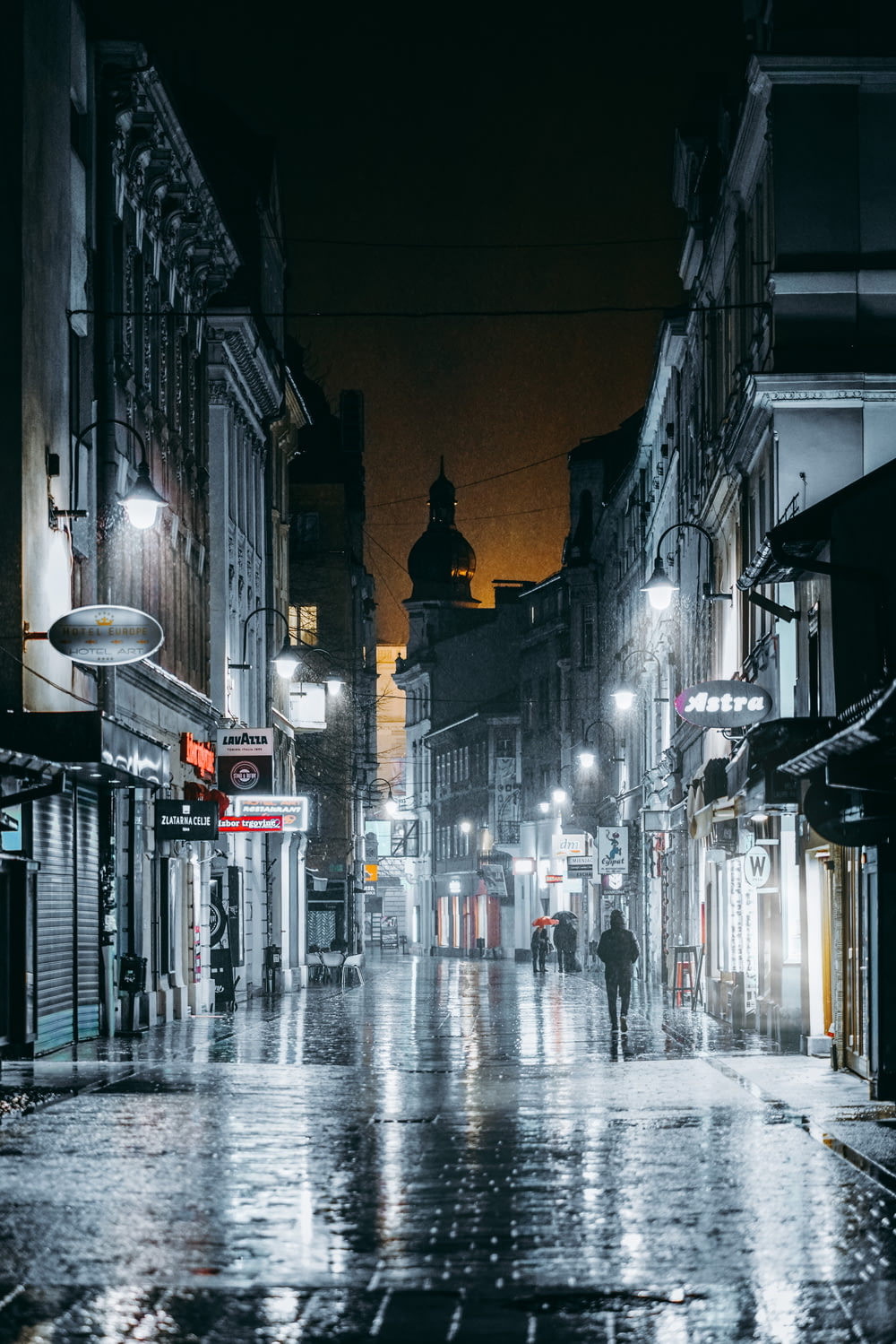 a person walking down a wet street